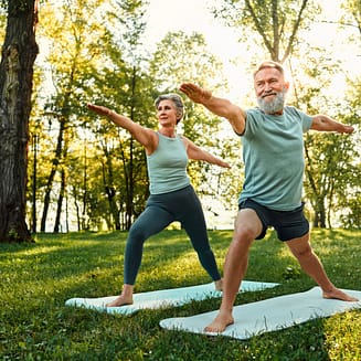 senior couple practicing yoga